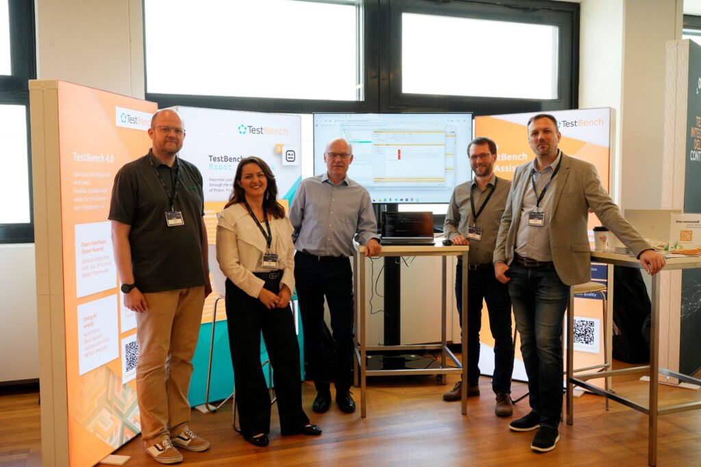 Group photo with Christian Kupfer, Dafina Galiani, Dierk Engelhardt, Michael Haderlein and Christian Mattitsch in front of the TestBench booth.